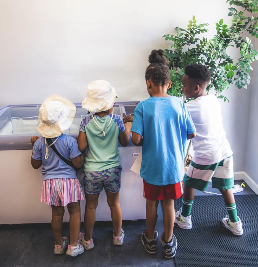 Children gathered at a freezer inside Kornr Store